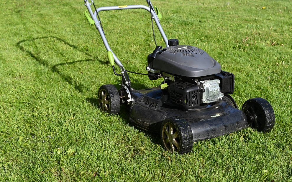 A lawnmower on a healthy green lawn