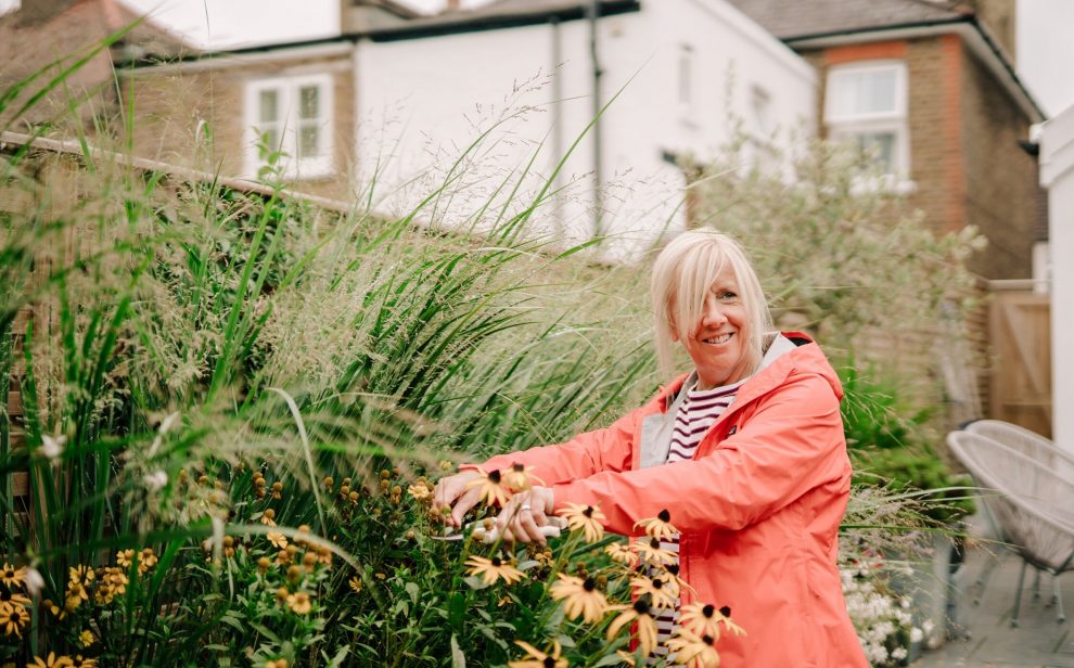 Happy person gardening flowers centre for better ageing