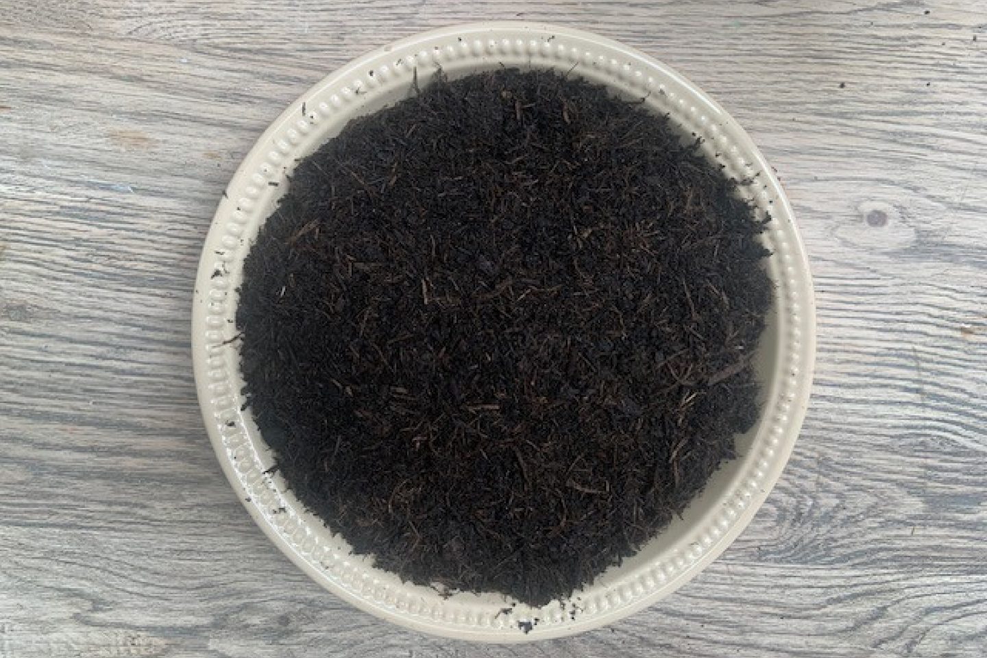 Grass hands covered with compost