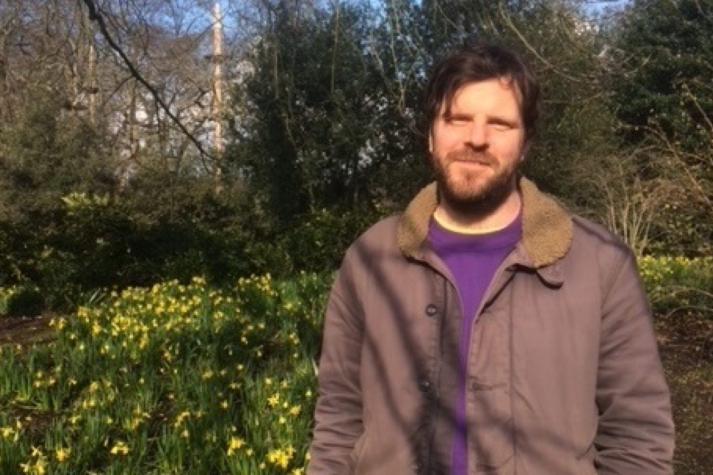 Mark Emery against a background of yellow daffodils