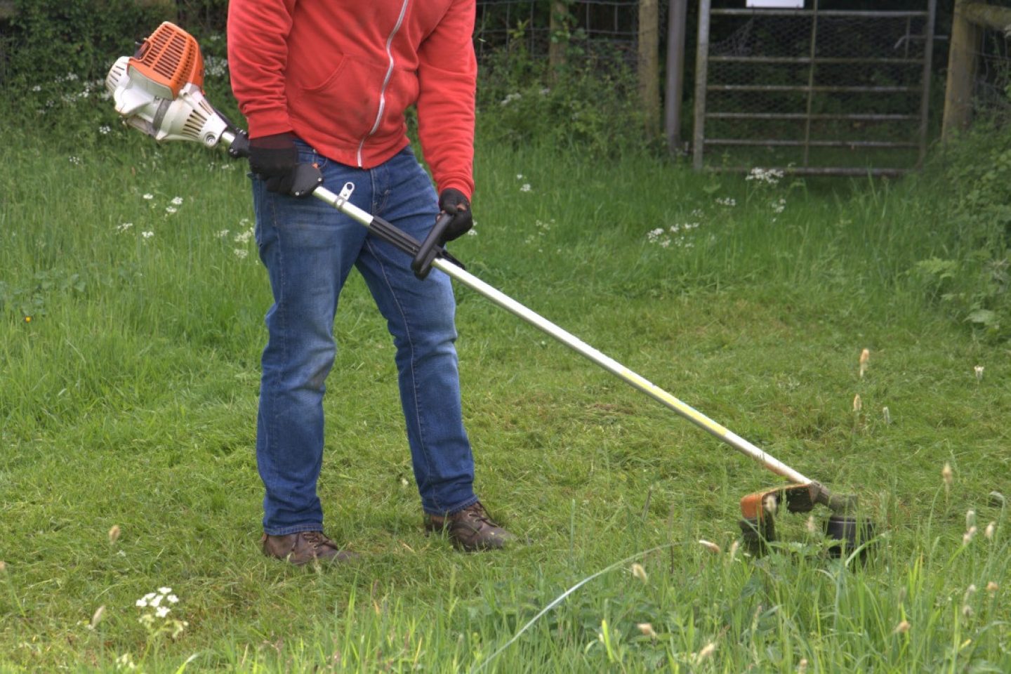 A grass strimmer is used to cut the grass