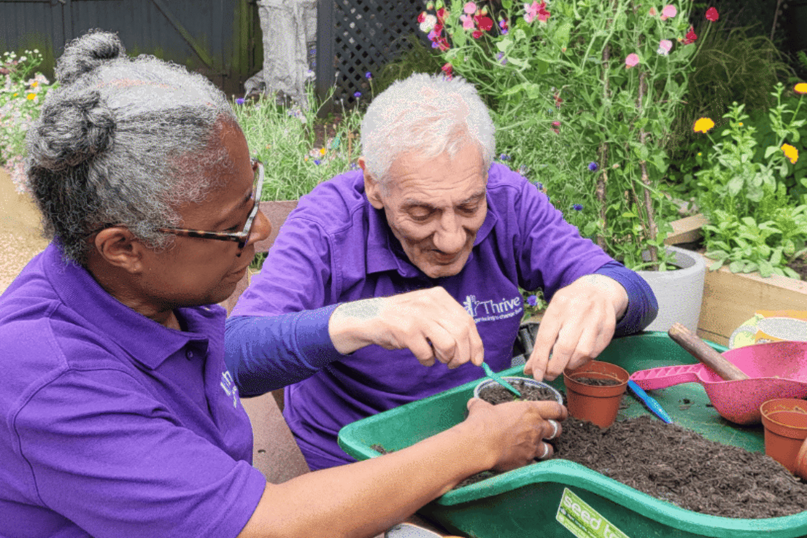 Thrive London Sanctuary Garden Volunteer Potting On Plants With Client Gardener