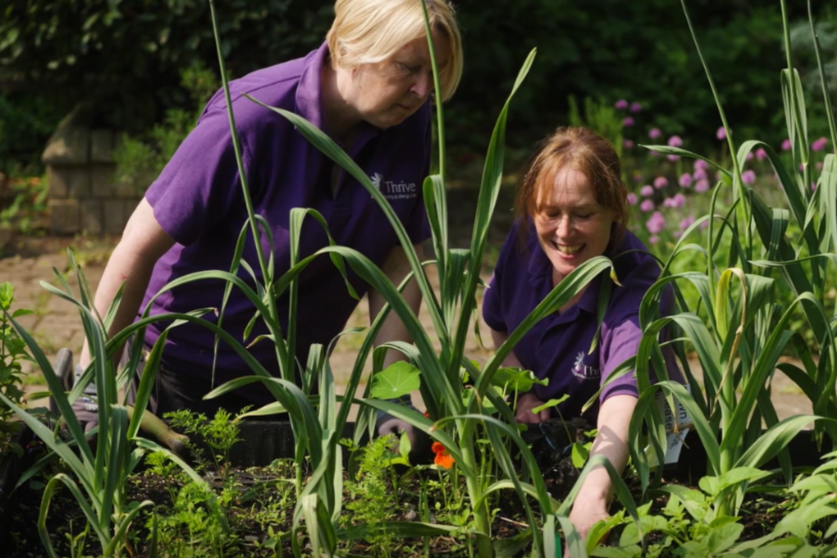Birmingham appeal client gardener lisa planting with practitioner