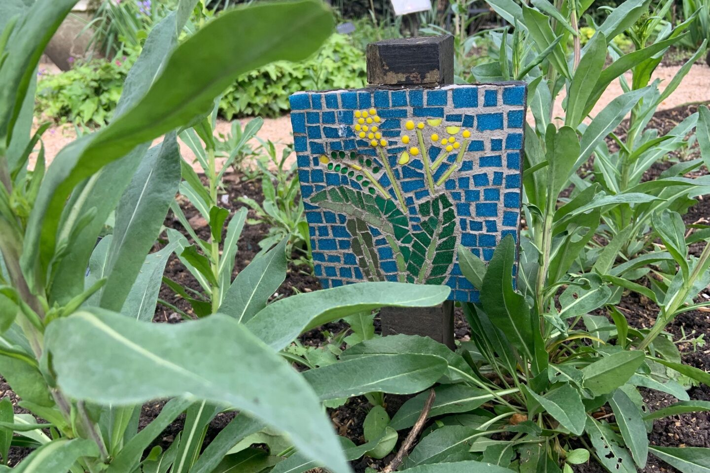 A mosaic based plant label at Thrive Battersea