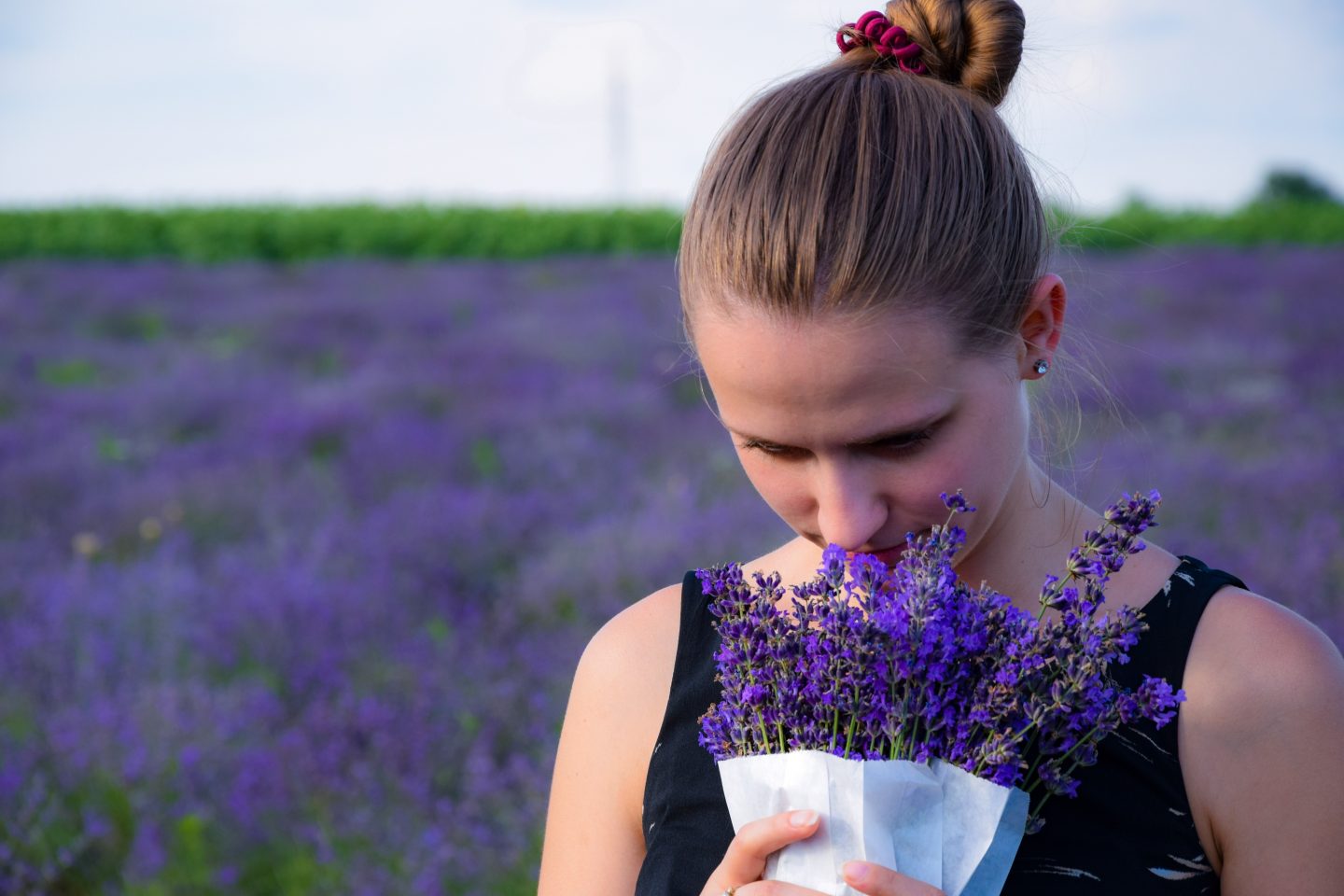 A person enjoy the scent of lavender