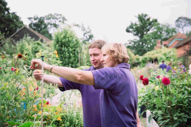 Chris L with vol looking at flower Charlie Garner 2019 small