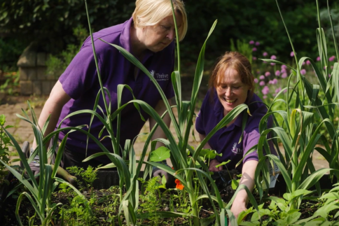 Birmingham appeal client gardener lisa planting with practitioner